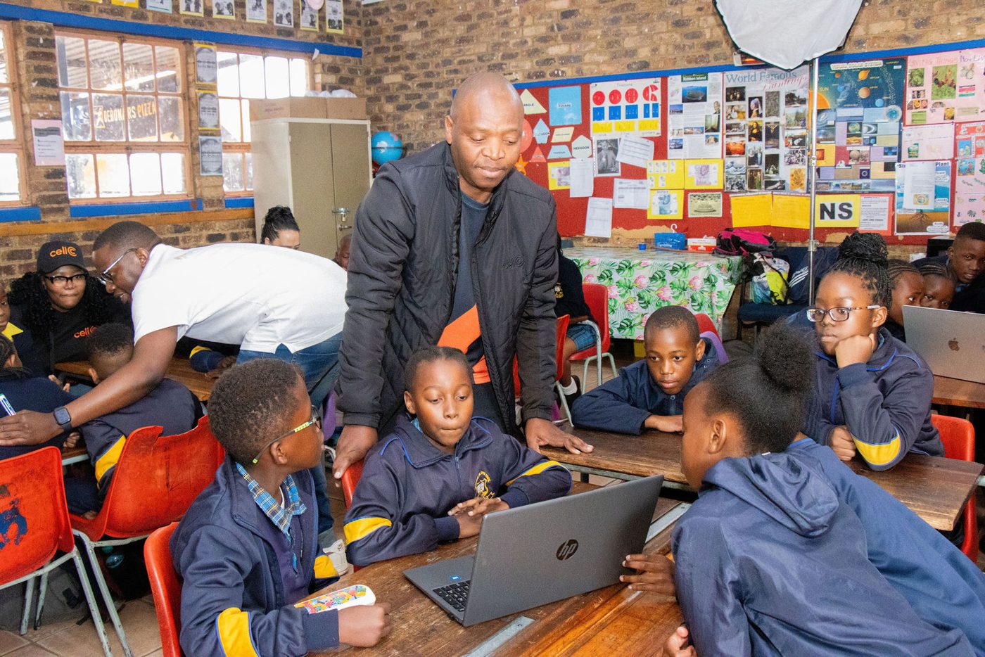 Learners raising hands and taking part in a group discussion.